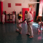 Students receiving his yellow belt from Sifu Ari